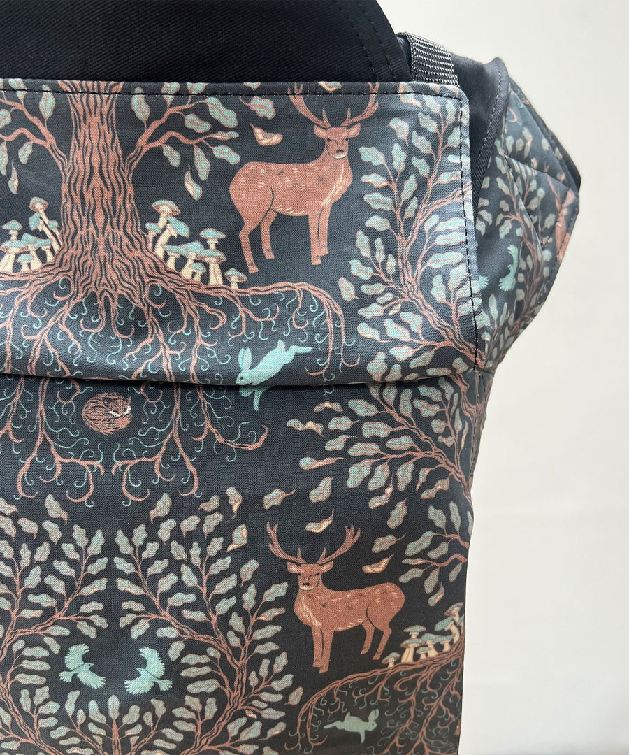 Integra Baby Carrier - Forest Tree. Forest Tree is a beautifully illustrated woodland design in soft organic cotton featuring intricate woodland trees and stags in muted colours on a black background.