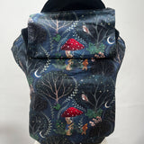 Integra Mr Rabbit Baby Carrier. Mr Rabbit is a whimsical illustrated print in soft organic cotton featuring a rabbit with a red mushroom umbrella taking a pet goldfish for a nighttime walk on an inky black background.