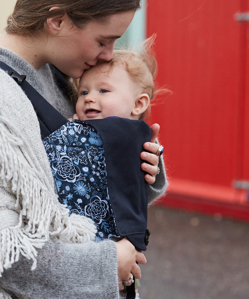 A person baby wearing a child in an integra carrier