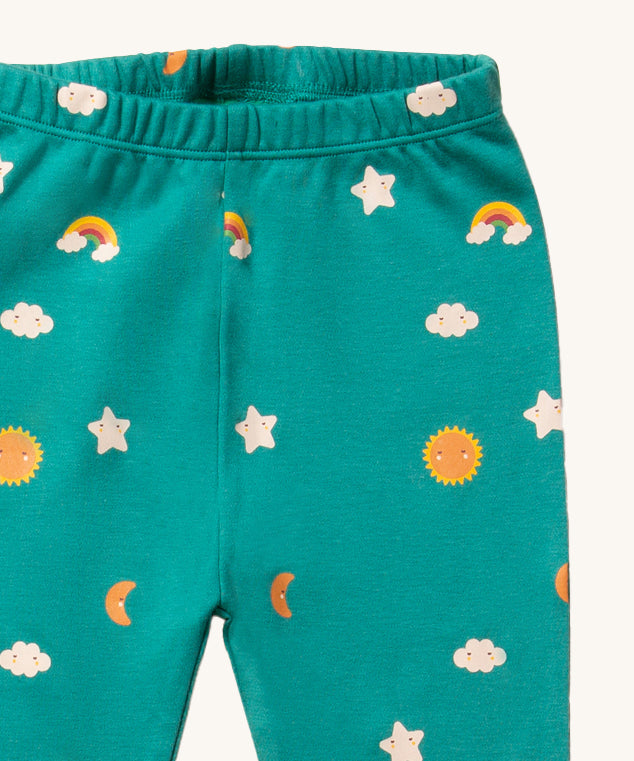 A closer look at the fun and cute rainbow, star, moon and sun print on the Little Green Radicals Organic Pyjama Bottoms - Turquoise Skies