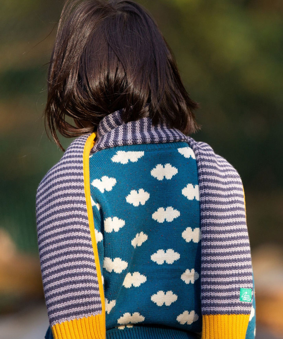 A closer view of the stripe knitted details on the Dream Blue Scarf. A soft, organic knit scarf being worn by a child