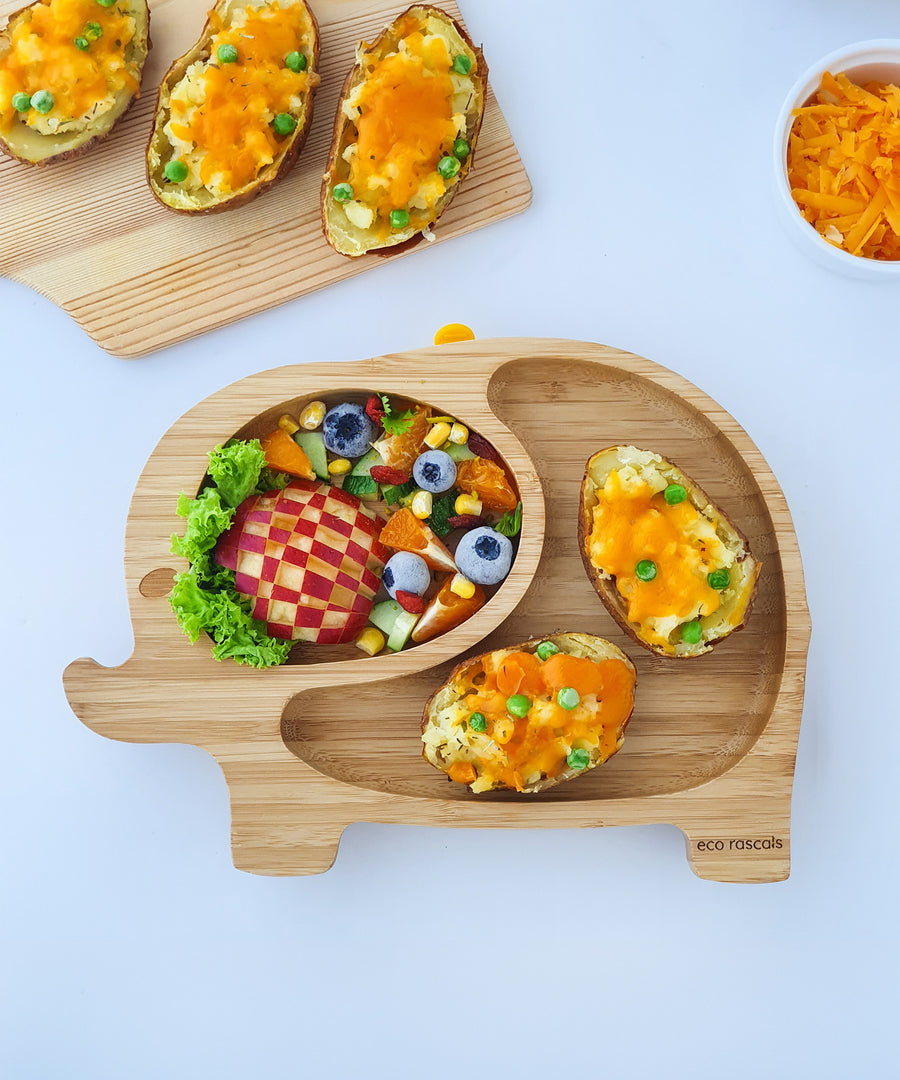 Elephant bamboo baby weaning plate with veg and cheese stuffet jacket potatoes and a fruit salad side. .