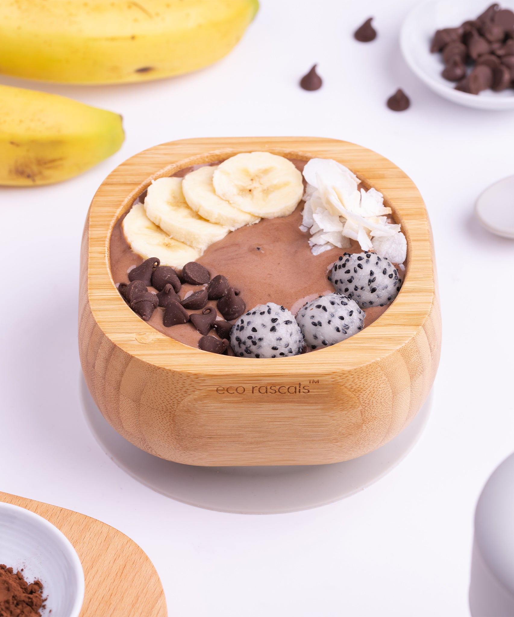 A chocolate desert with fresh banana slices in the Eco Rascals Bamboo Bowl & Spoon Weaning Set in grey silicone.