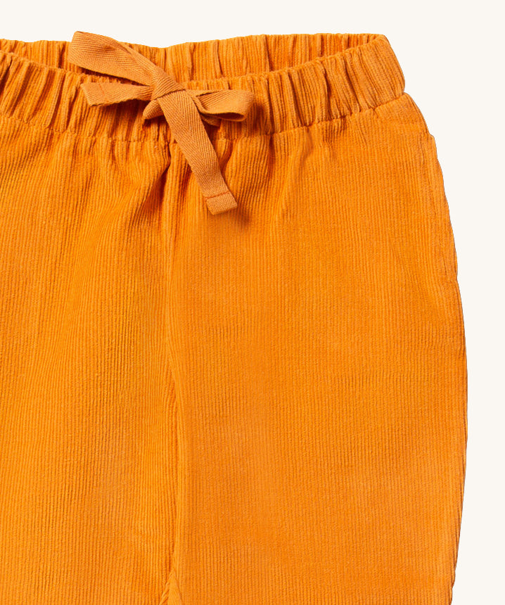 A closer look at the comfy corduroy fabric, elasticated waistband and pull through tie on the Corduroy Comfy Trousers - Golden Ochre