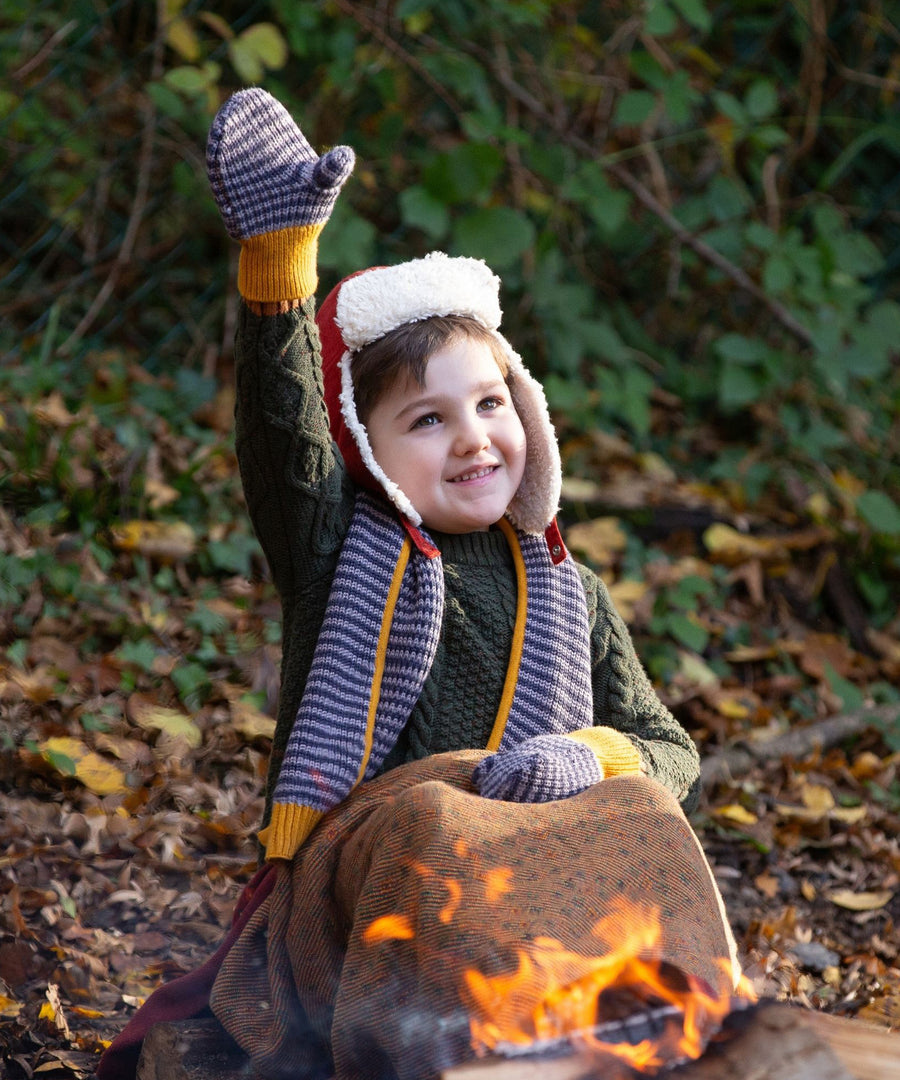 A child raising their hand to show the Dreamy Blue Striped Knitted Mittens