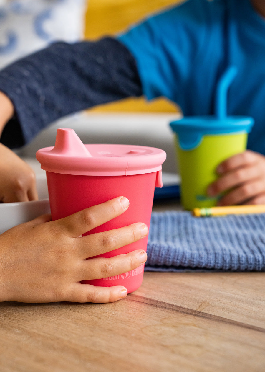 Little Kids hands on Kid Cups drinking cups