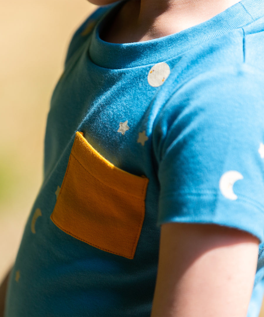 A close up of the yellow pocket on the top of the LGR Dawn Organic T-Shirt & Jogger Playset