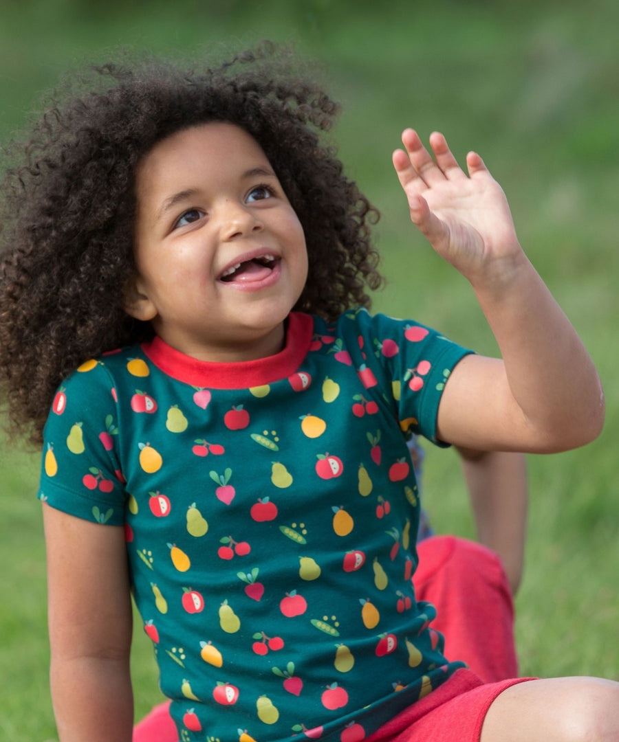 A child outside, wearing the LGR Vegetable Patch Short Sleeve T-Shirt