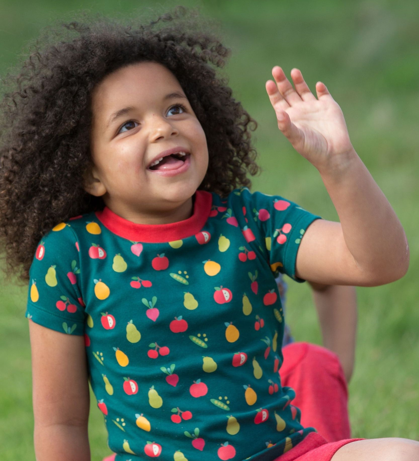 A child outside, wearing the LGR Vegetable Patch Short Sleeve T-Shirt