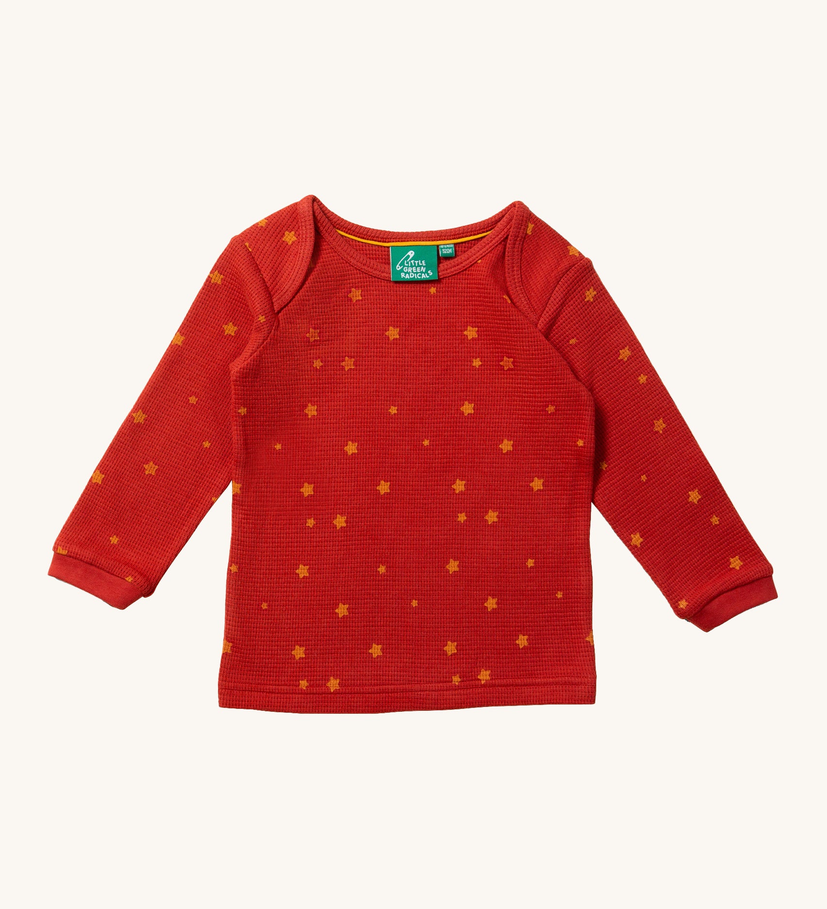 The top of the Little Green Radicals Waffle T-Shirt & Jogger Playset - Hazelnut Stars, in red fabric and delicate golden stars print