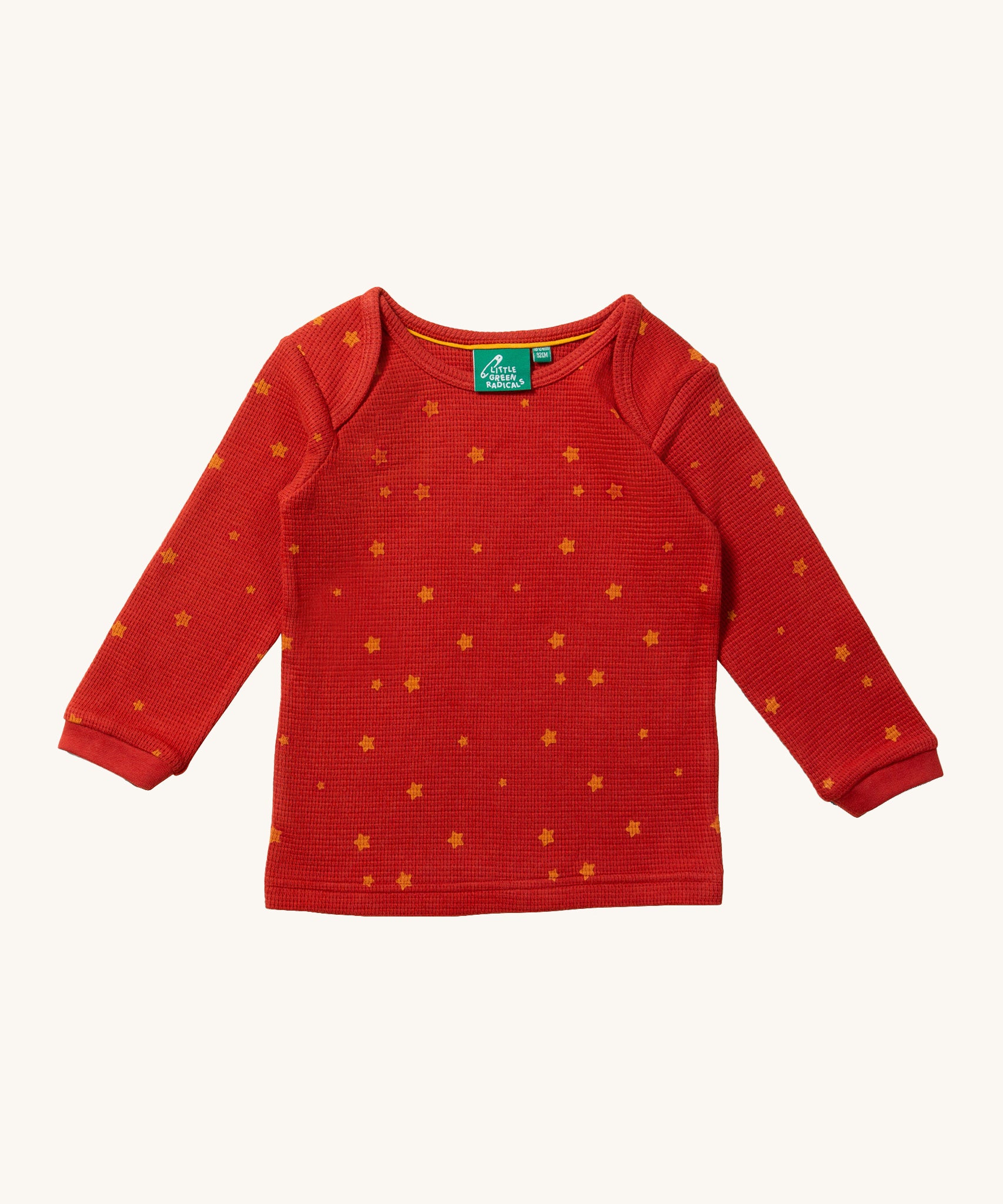 The top of the Little Green Radicals Waffle T-Shirt & Jogger Playset - Hazelnut Stars, in red fabric and delicate golden stars print