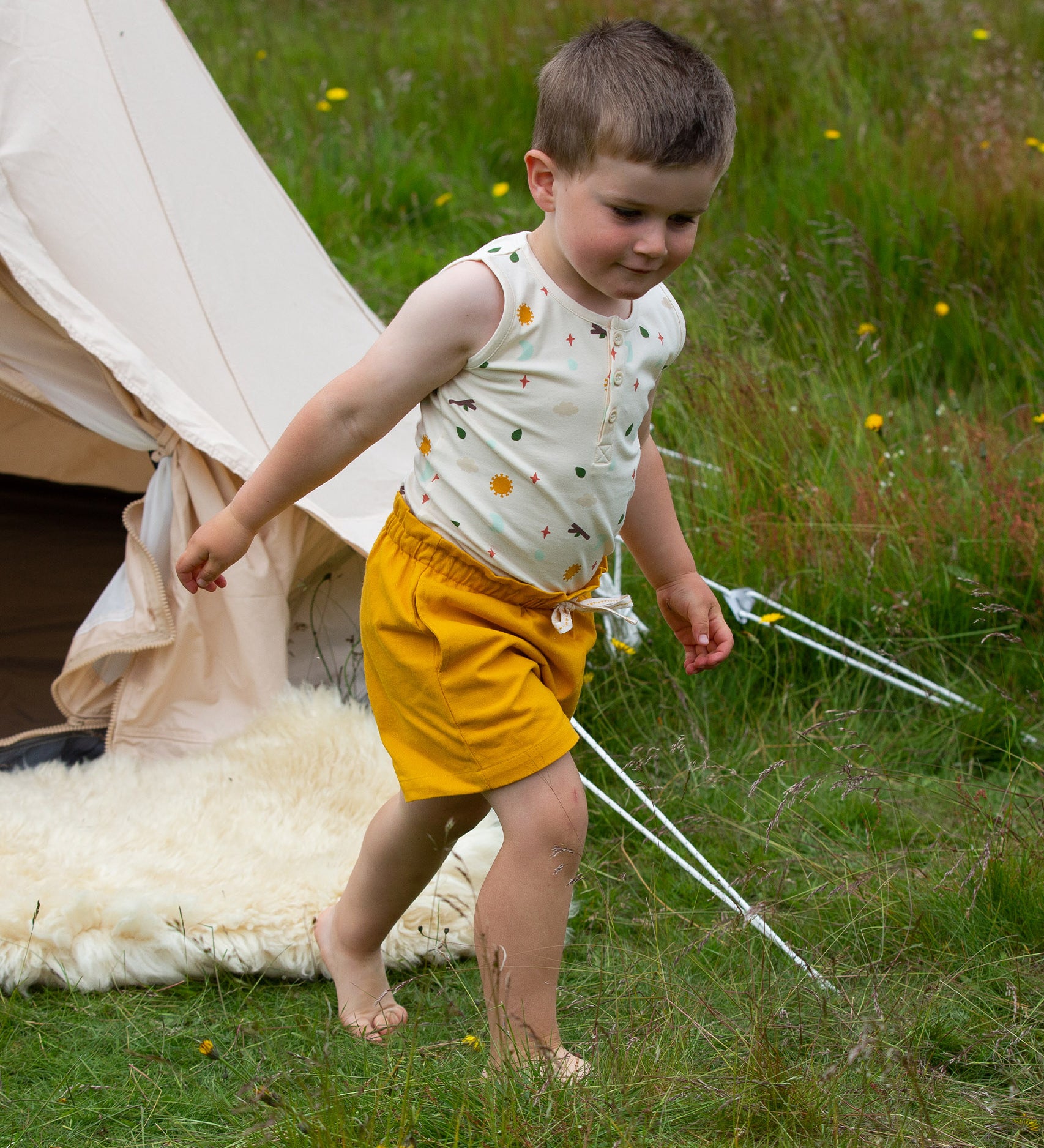 A child wearing the Adventure Print vest top, from the LGR Adventure Organic Vest Set - 3 Pack