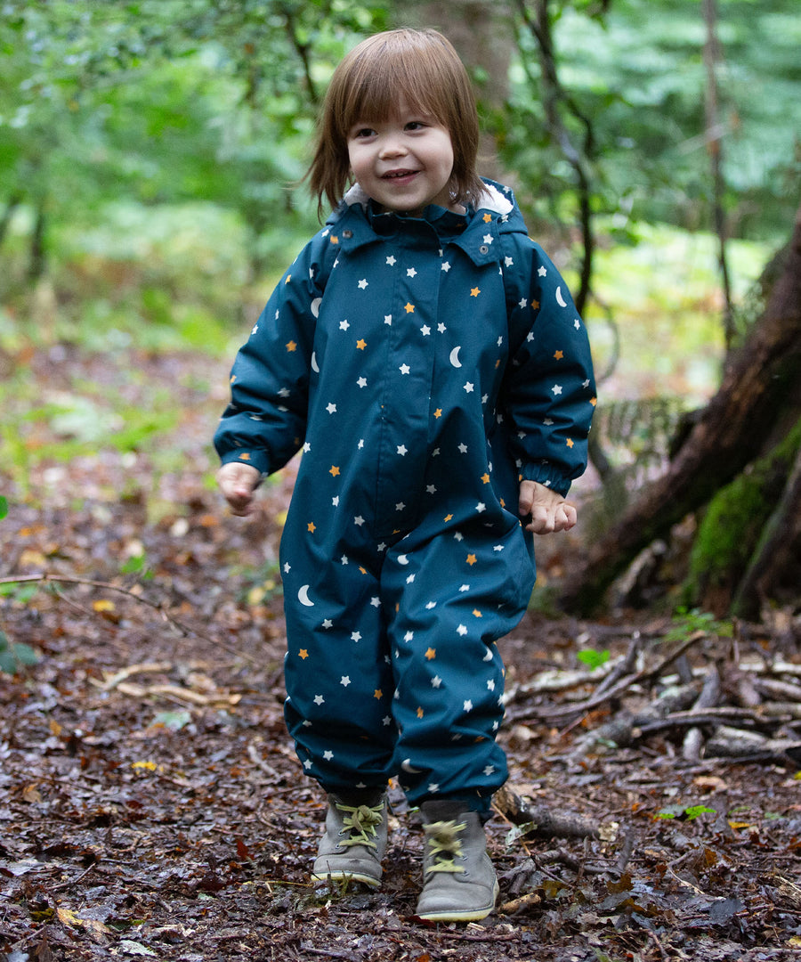 A child playing in the forest, wearing the LGR Starry Night Waterproof Winter Suit