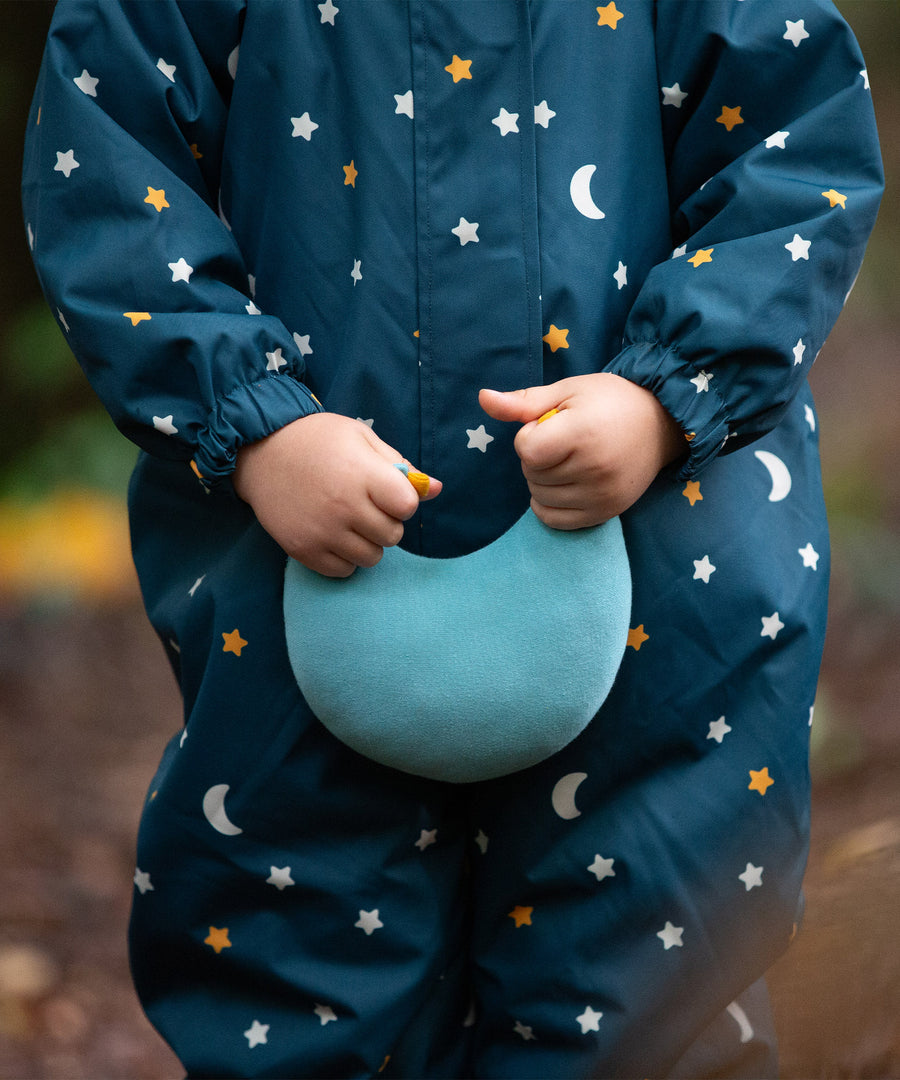 A closer view of the LGR Starry Night Waterproof Winter Suit, with a child holding a light blue LGR moon cushion