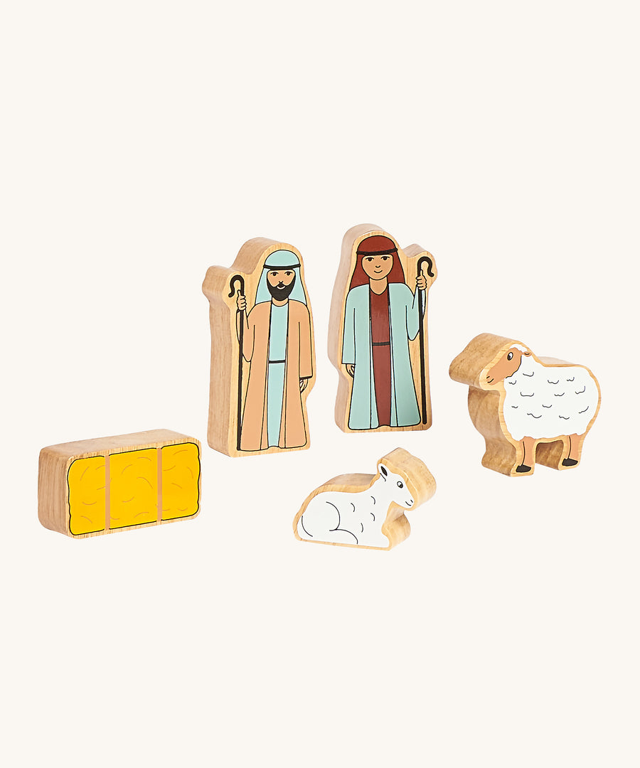 The Shepard and Sheep wooden figures from the Lanka Kade Deluxe Nativity Set on a cream backgroud