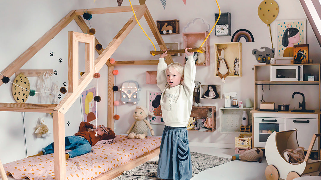 Child in a playroom, playing with the Lillagunga swing set