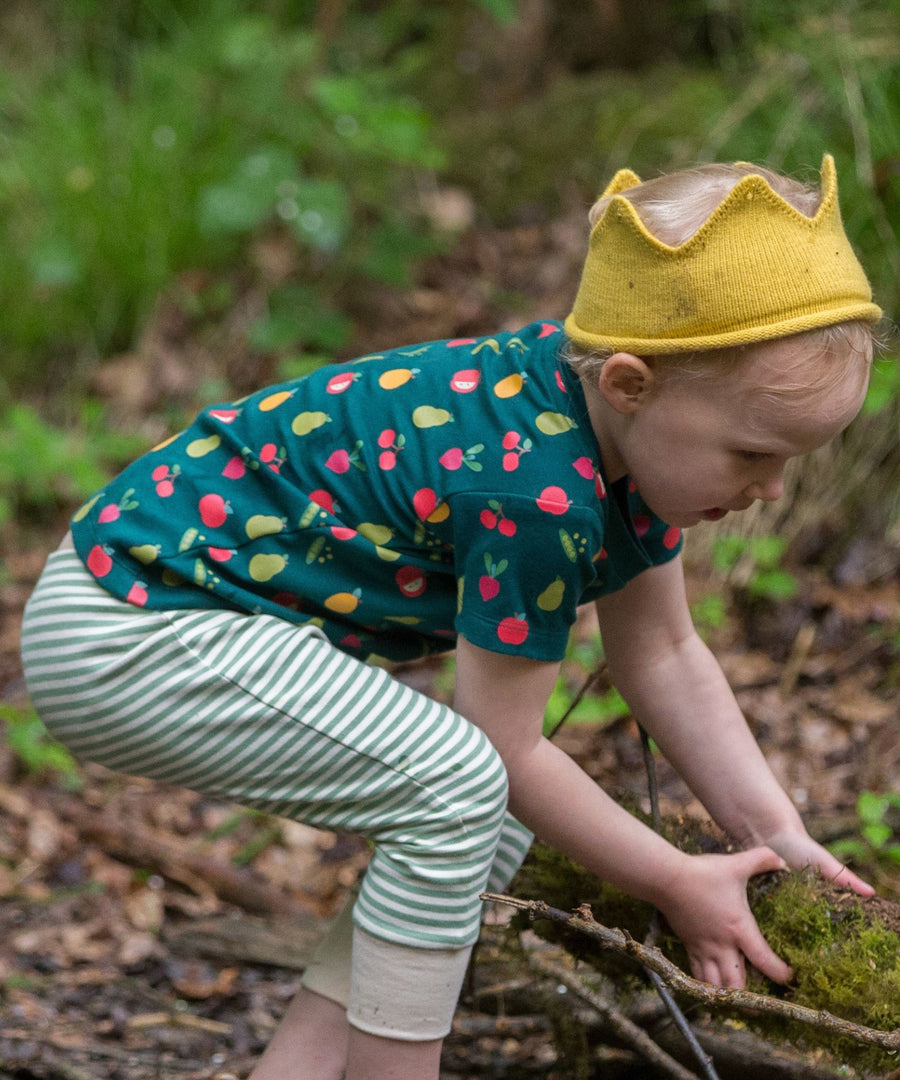 A child playing in a forest, wearing the LGR Vegetable Patch Short Sleeve T-Shirt