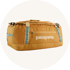 Patagonia duffel bag on cream background to represent luggage at Babipur.
