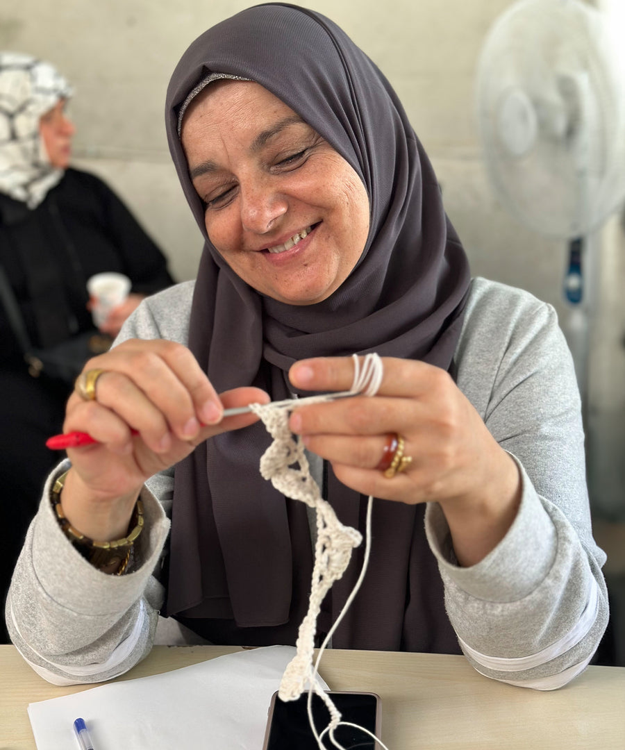 A Syrian Refugee crocheting the start of a teddy