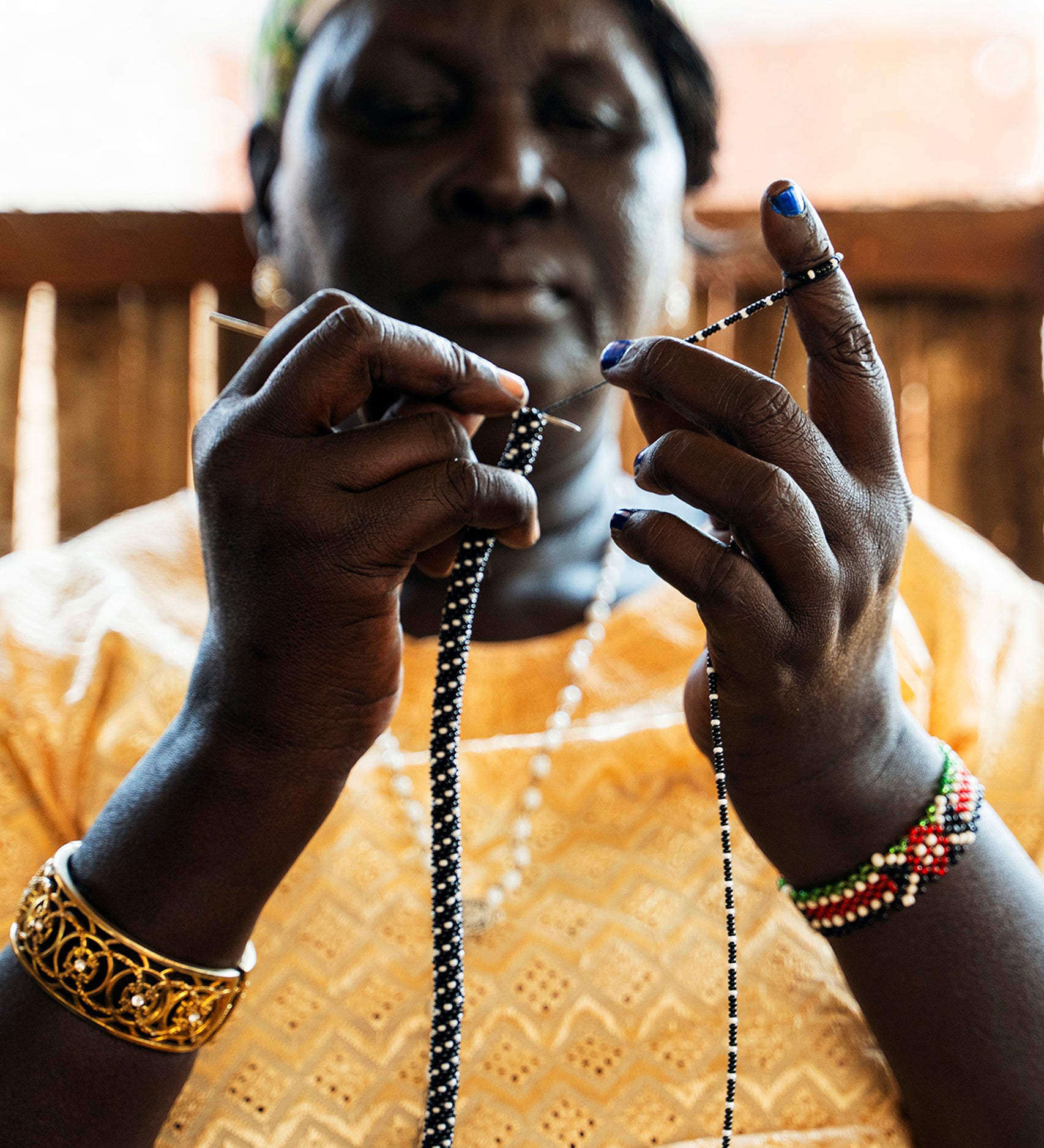 The intricate bead making skills of artisan bead crafting refugees