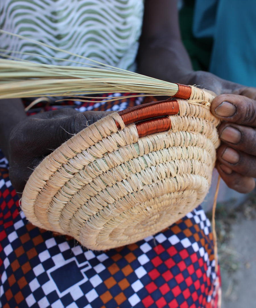 A look at the hand making process of weaving the copper wire to create a part of the bowl