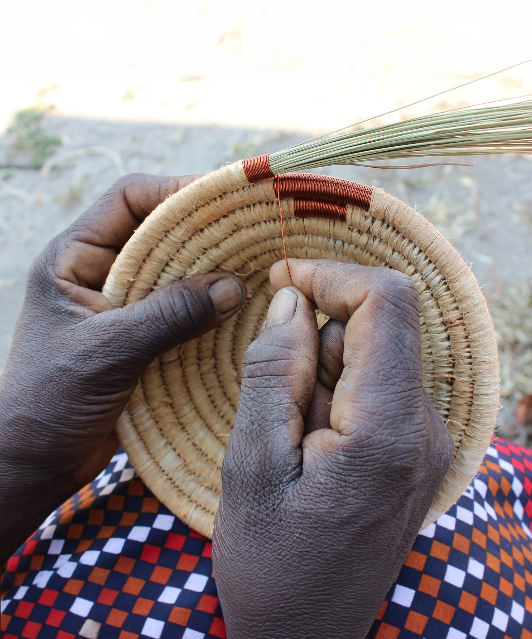 A look at the hand making process of weaving the copper wire to create a part of the bowl