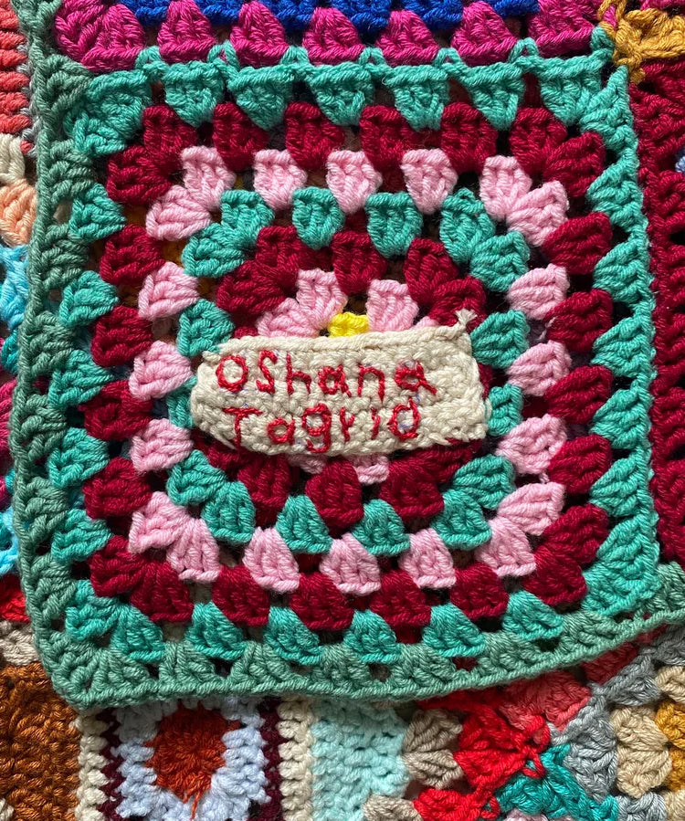 A close up of the Oshana patch on the MADE51 Habibi Small Handmade Crochet Blanket