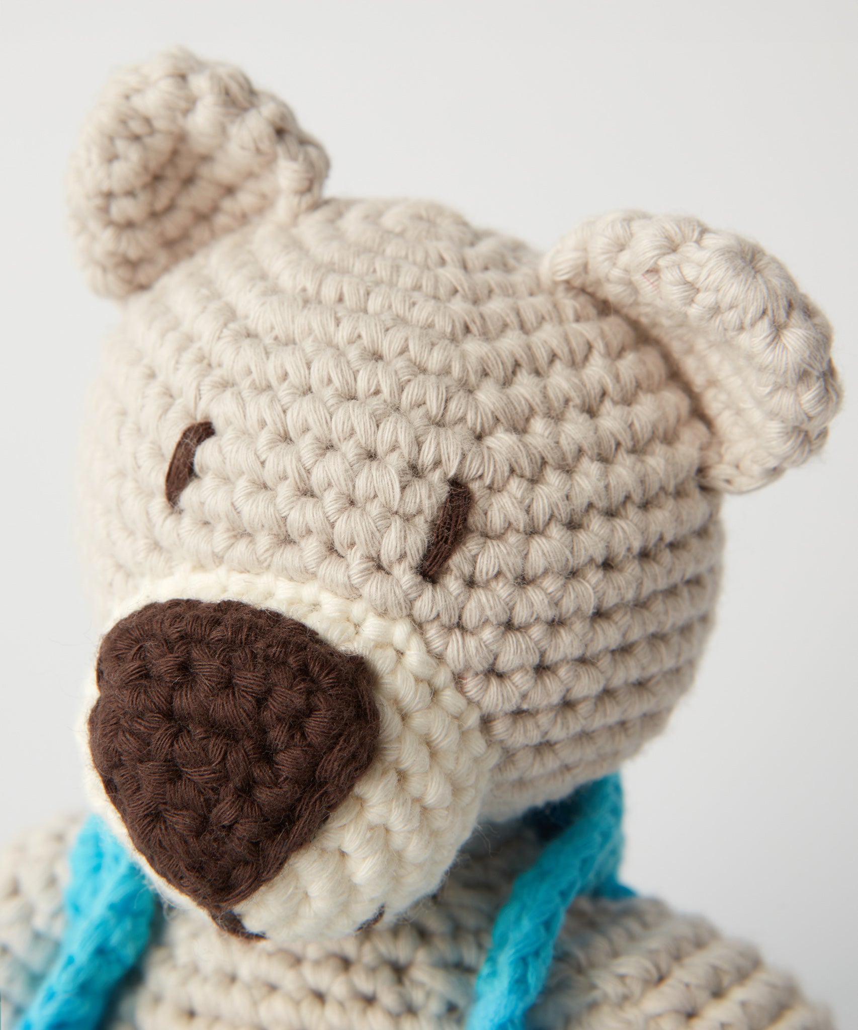 A closer look at the crochet detailing on the face of the Peace Bear