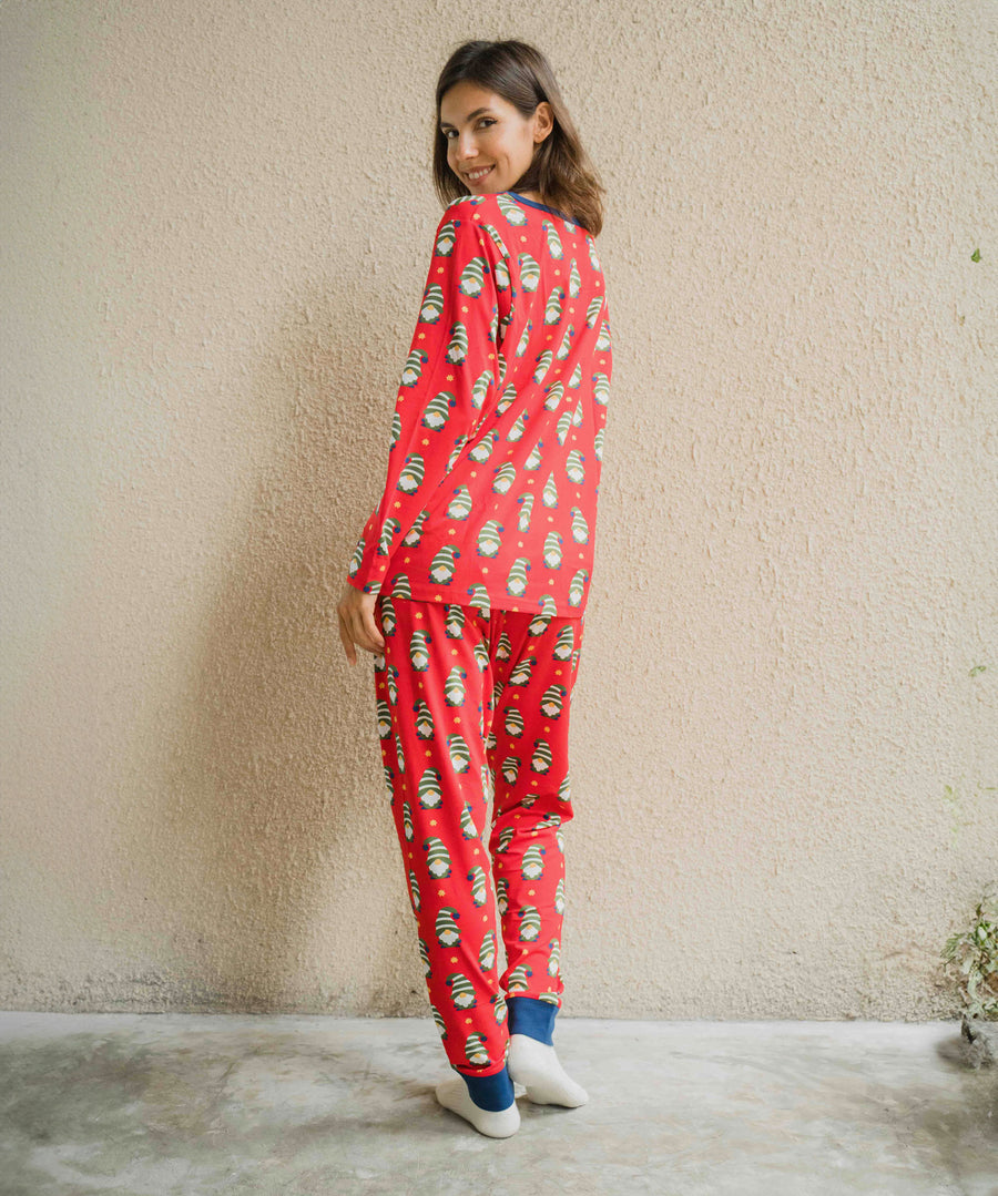 A woman wearing a Maxomorra Swedish Santa Adult Long Sleeve Pyjama Set standing in front of a beige coloured wall. The woman is facing away from the camera showing teh back of the pyjamas. 