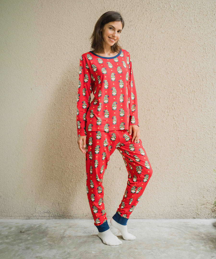 A woman wearing a Maxomorra Swedish Santa Adult Long Sleeve Pyjama Set standing in front of a beige coloured wall.