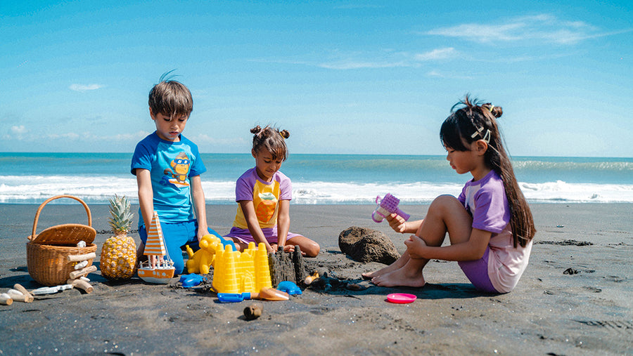 Kids on the beach dressed in Maxomorra outfits