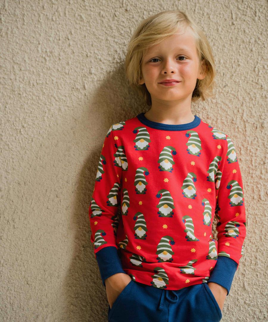 A child wearing a Maxomorra Swedish Santa Long Sleeve top. The child is stood in front of a beige coloured wall.