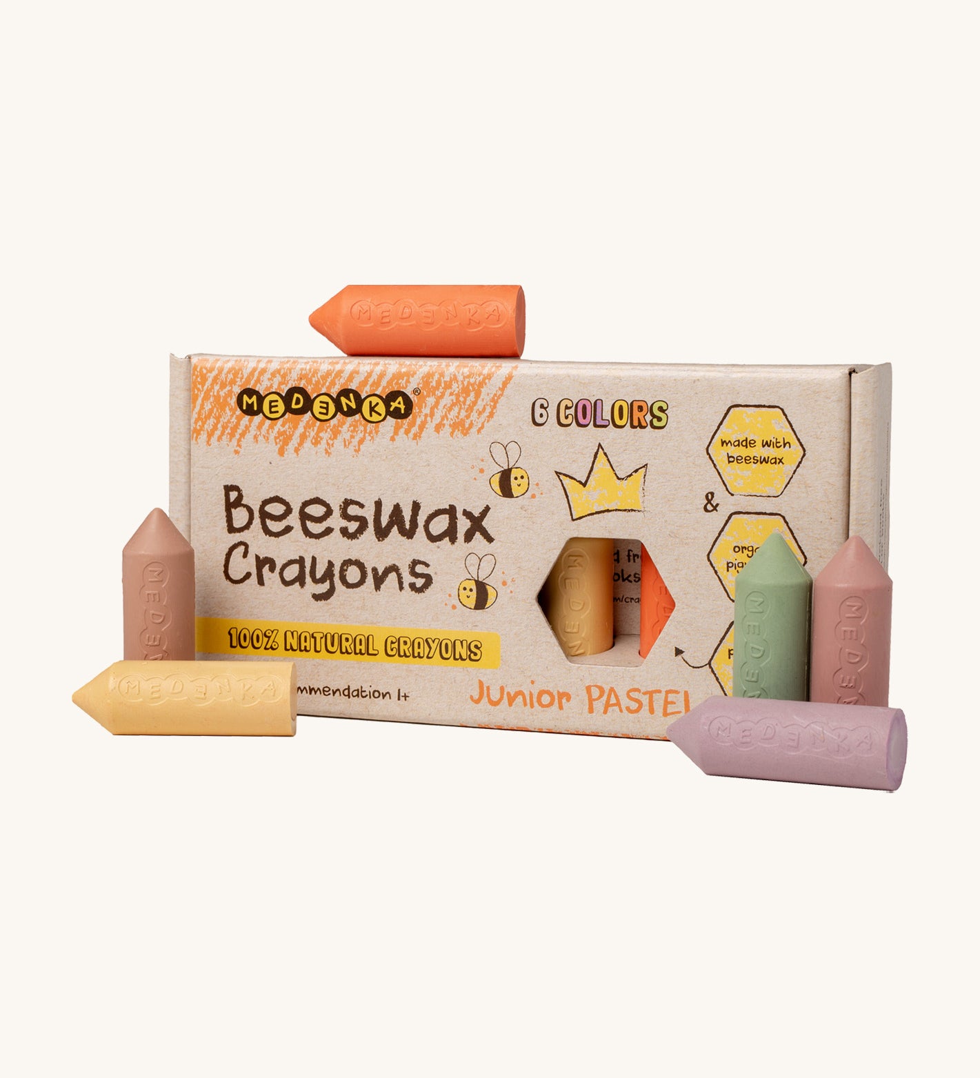 Medenka junior pastel beeswax crayons standing next to their cardboard box packaging.