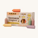 Medenka junior pastel beeswax crayons standing next to their cardboard box packaging.