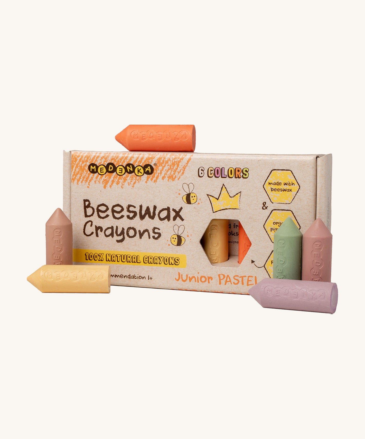 Medenka junior pastel beeswax crayons standing next to their cardboard box packaging.