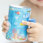 A baby holding a soapy box of Medenka beeswax bath crayons in the bath. 