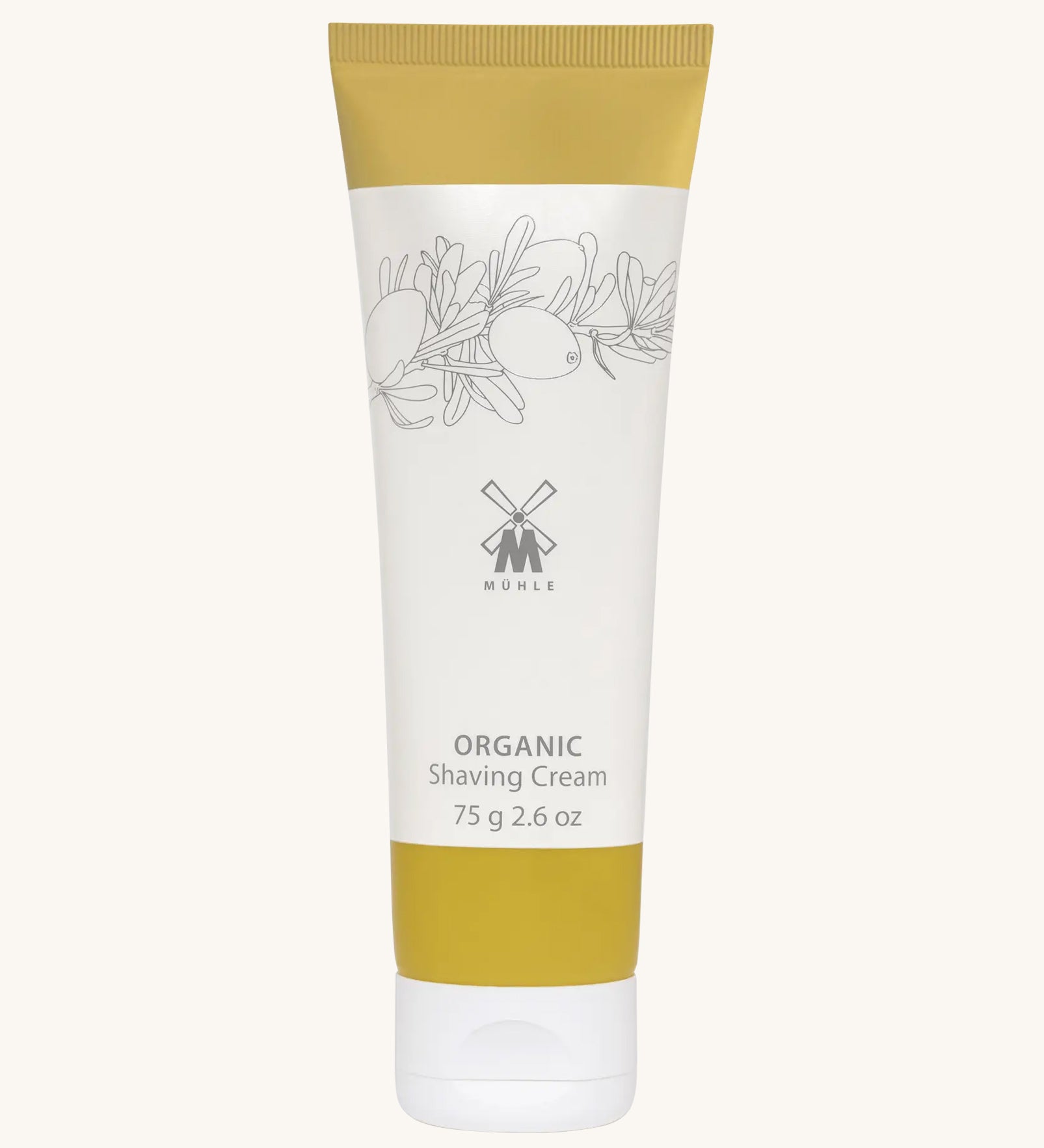 MÜHLE Organic Shaving Cream in a mustard and white tube with delicate olive branch design on the packaging and the Muhle logo in the middle. On a cream background