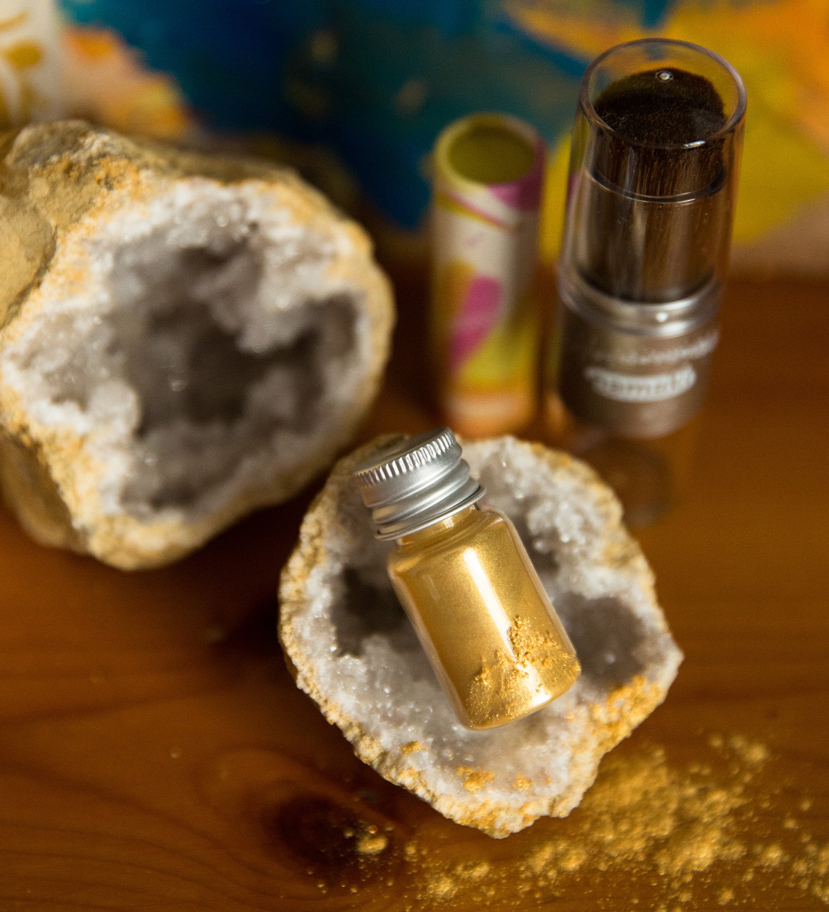 The  Namaki Gold Fox Sparkling Pouch make up on a wooden table with a crystal geode