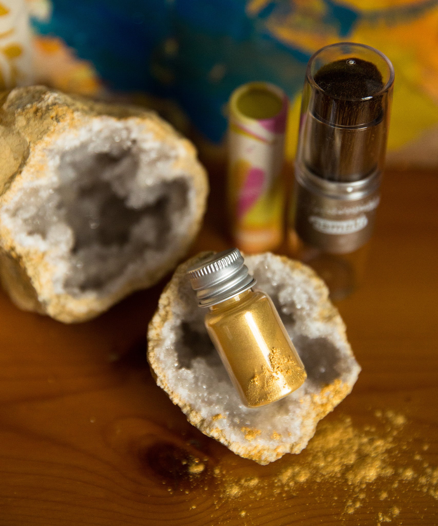 The  Namaki Gold Fox Sparkling Pouch make up on a wooden table with a crystal geode