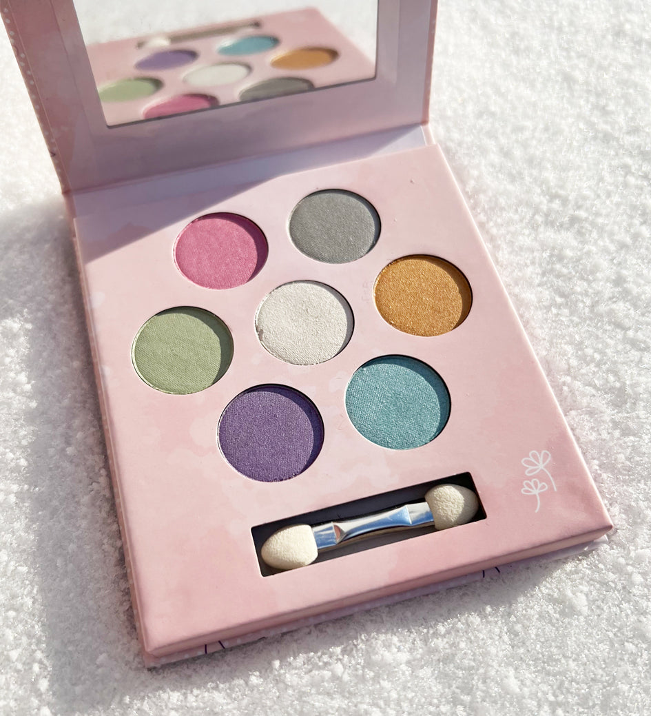 The inside of the Namaki Natural Eyeshadow Pallet - Fawn. The image shows the eye shadow colours which are pink, grey, gold, white, green, blue and purple