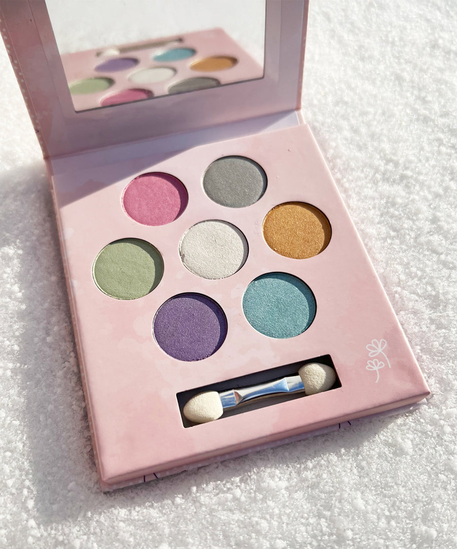 The inside of the Namaki Natural Eyeshadow Pallet - Fawn. The image shows the eye shadow colours which are pink, grey, gold, white, green, blue and purple