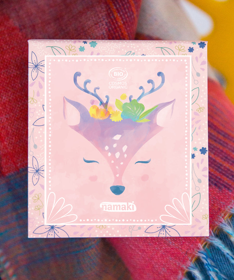 The Namaki Natural Eyeshadow Pallet - Fawn on top of a colourful blanket