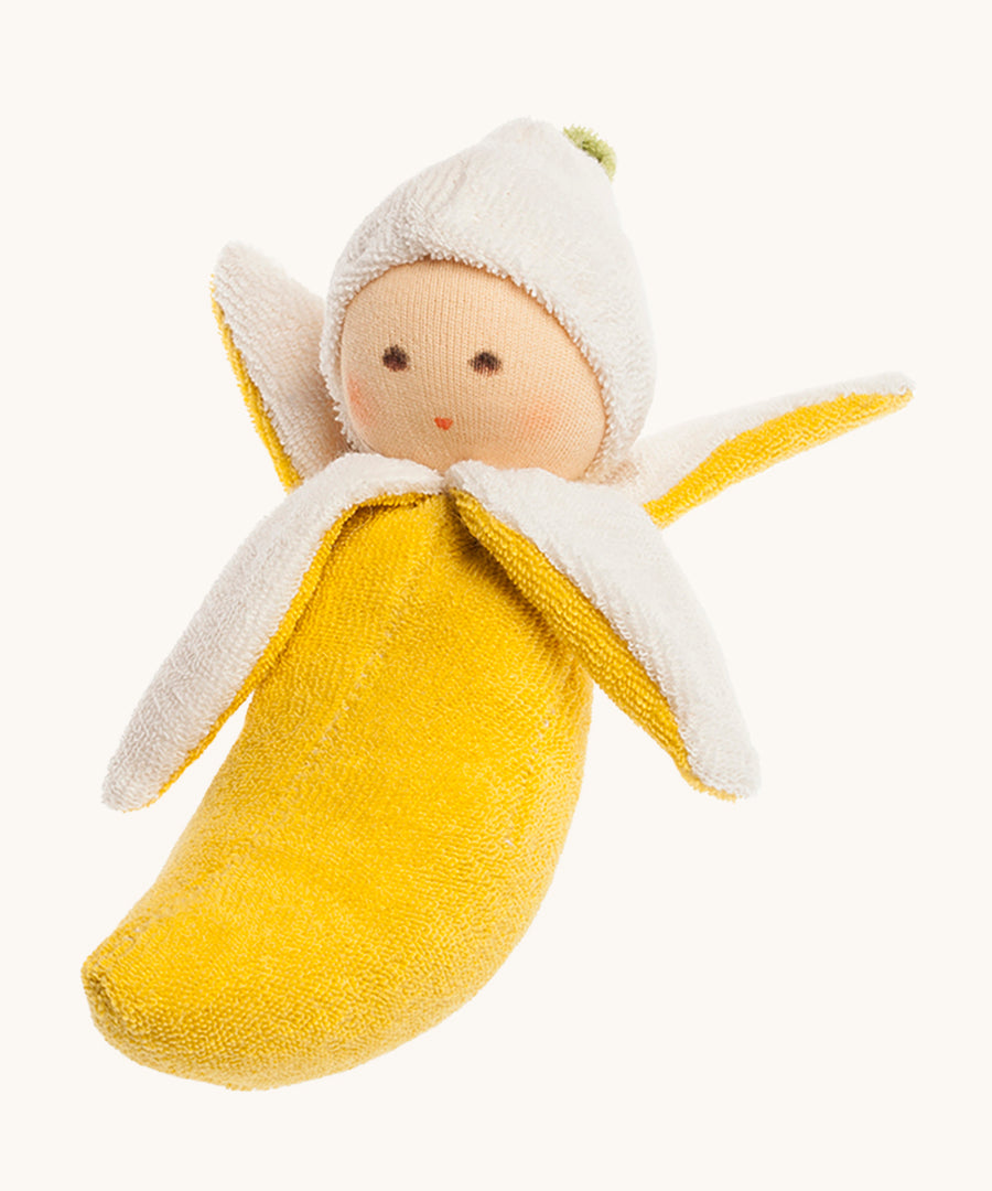 Nanchen Banana Rattle Doll. A beautifully handmade rattle toy in the shape of a banana, perfect for little hands to grasp. The rattle has 4 peeled banana parts and a cute little doll head at the top. On a cream background