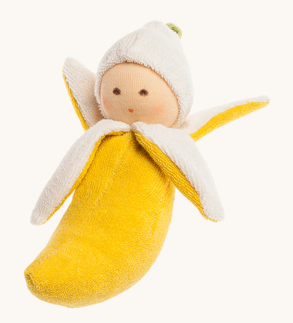 Nanchen Banana Rattle Doll. A beautifully handmade rattle toy in the shape of a banana, perfect for little hands to grasp. The rattle has 4 peeled banana parts and a cute little doll head at the top. On a cream background