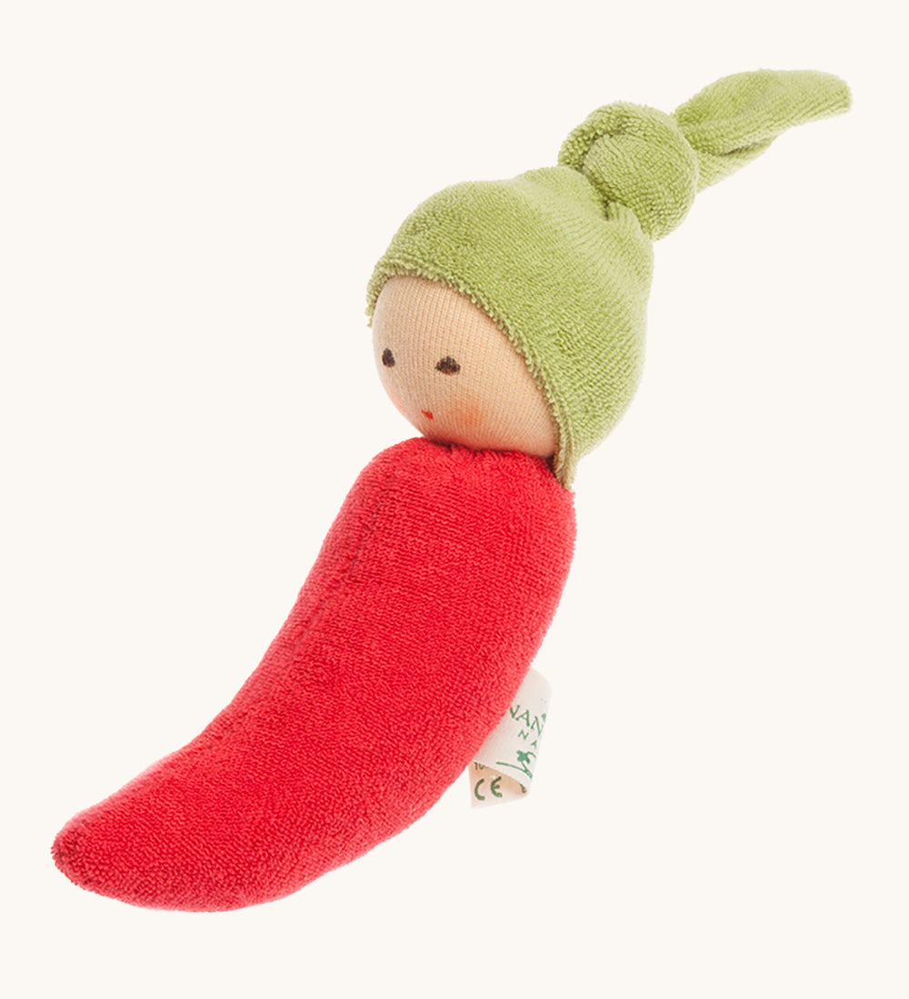 Nanchen Chilli Rattle Doll. An adorable hand crafted, soft rattle toy in the design of a red chili pepper, with a cute green hat with a knot on top. On a cream backgorund