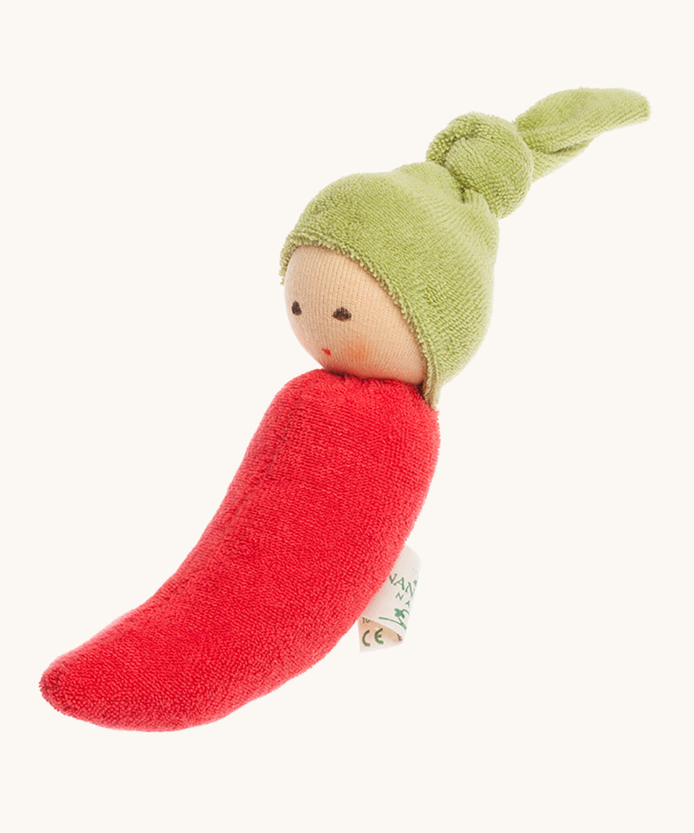 Nanchen Chilli Rattle Doll. An adorable hand crafted, soft rattle toy in the design of a red chili pepper, with a cute green hat with a knot on top. On a cream backgorund