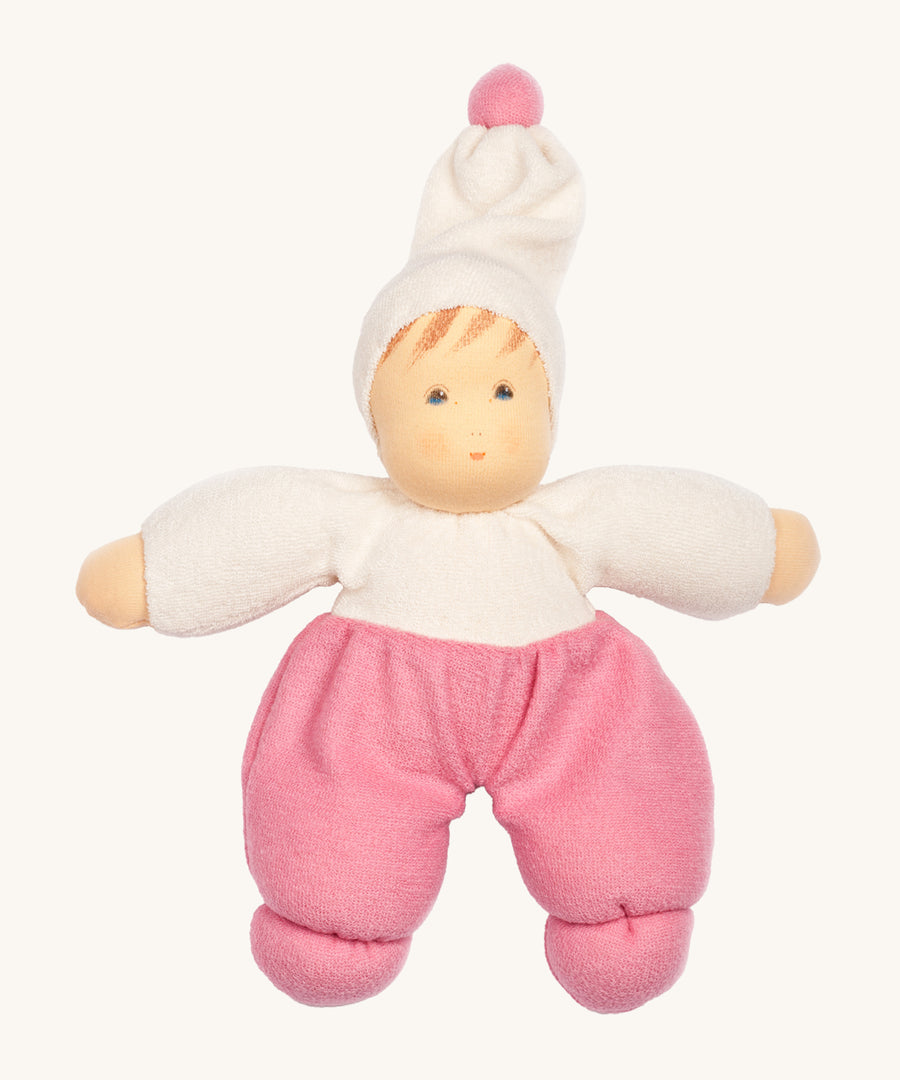 Nanchen Möpschen Doll - Pink. A soft and cuddly doll with pink trousers, a white top and white hat with a pink bobble on top