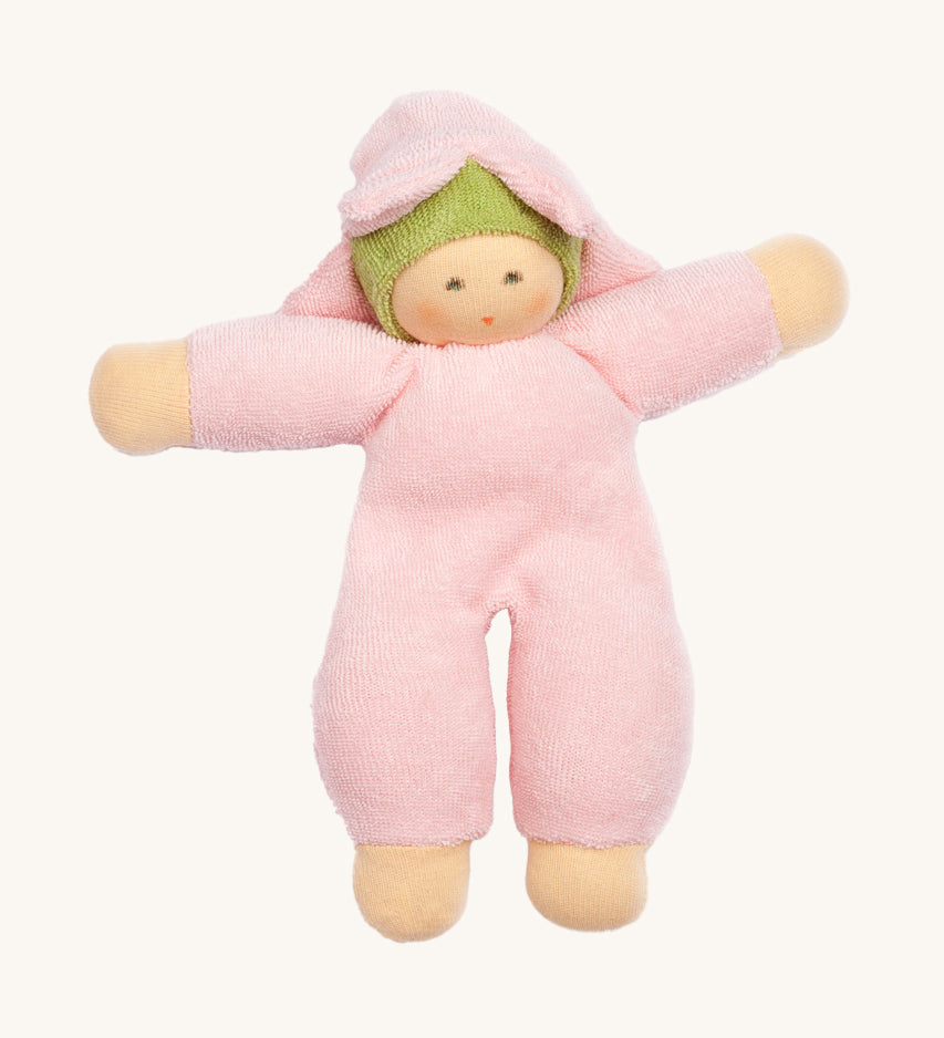 The Nanchen Flower Fairy Rattle Doll as a soft Pink terry material body, with a pretty pink terry material hat in the shape of a flower, and a green terry strip of fabric just under the hat