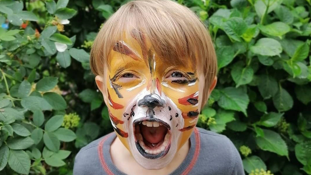 Picture of a boy wearing tiger face paint