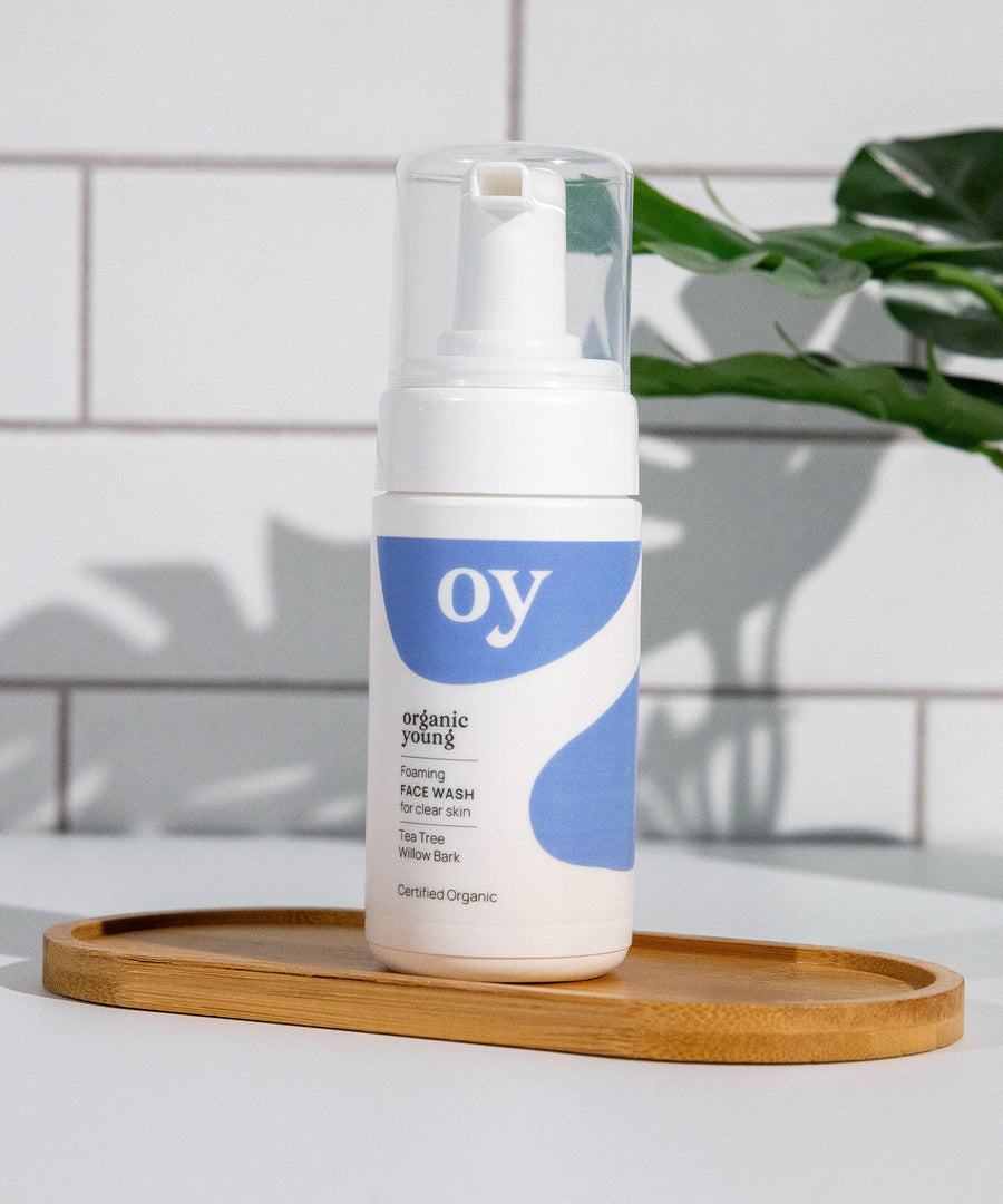 The OY Face wash on a wooden board